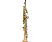 A gold soprano saxophone standing upright on a white background.