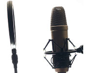 A microphone with a pop filter positioned in front, set against a plain white background.